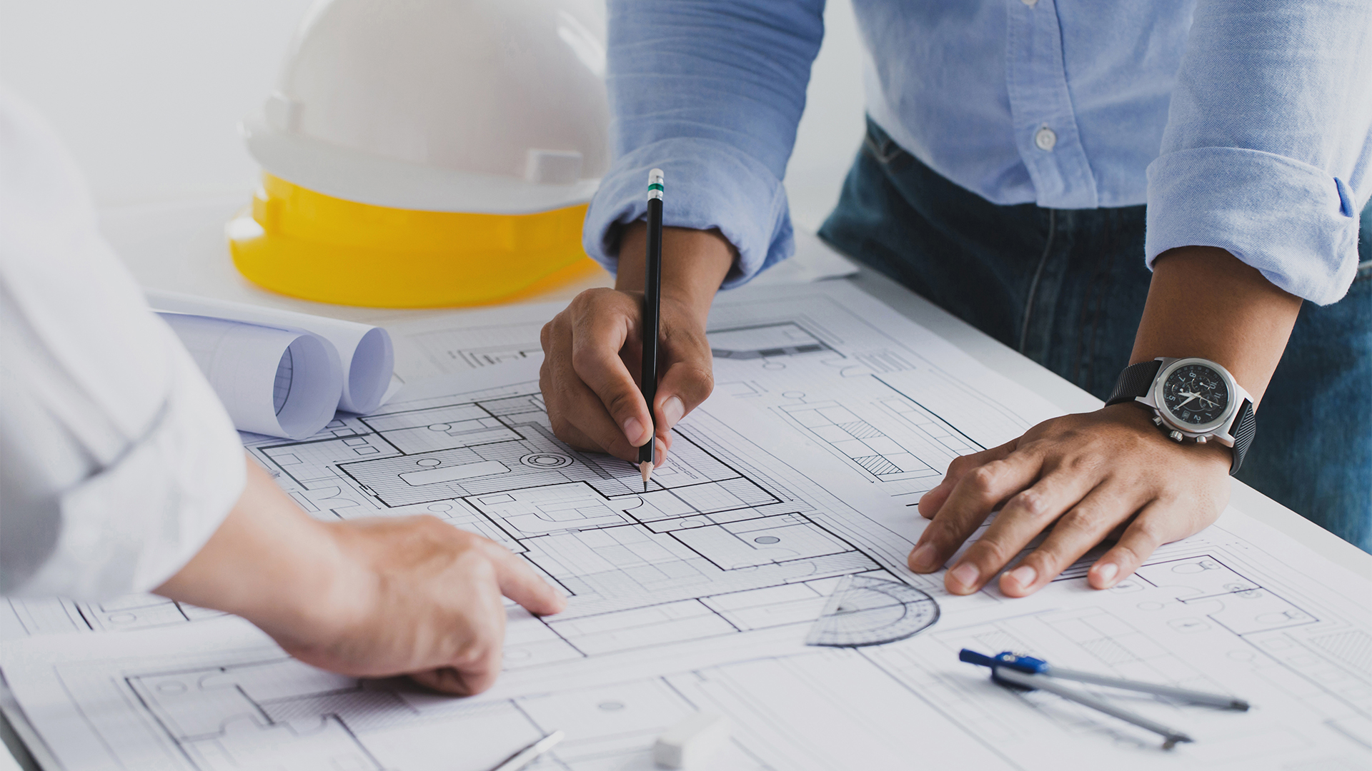 engineer meeting for an architectural project. working with partner and engineering tools working on blueprint architectural project at the construction site at desk in the office.
