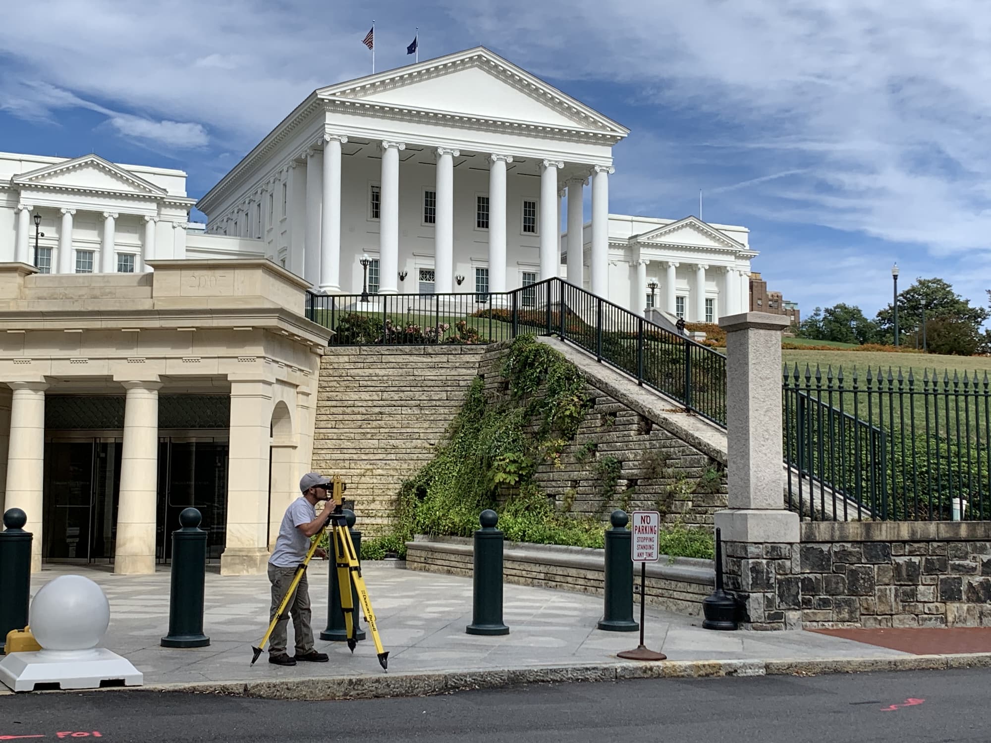 surveyor in front of civic building